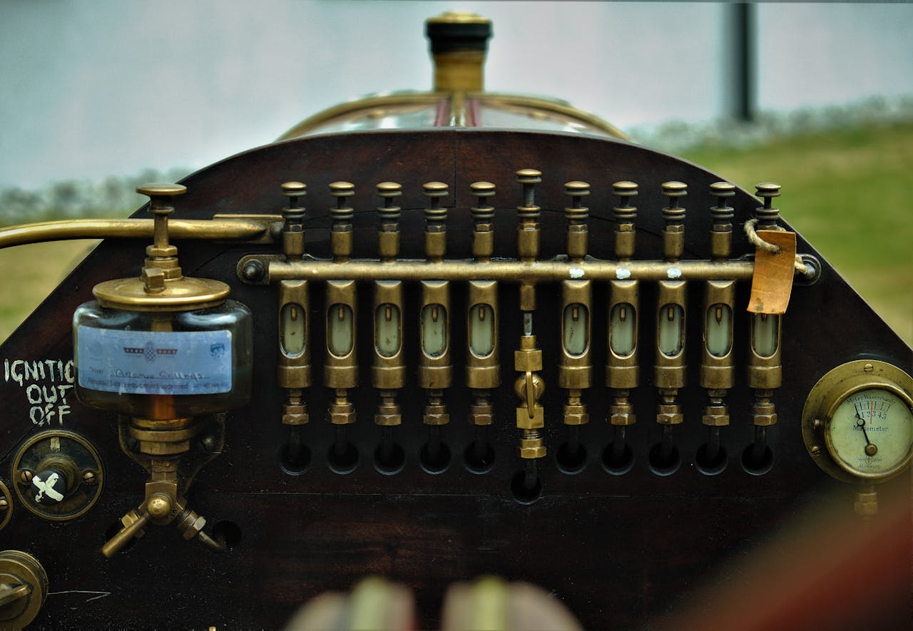 A close-up of a vintage mechanical control panel with brass levers and gauges, symbolizing outdated technology in need of modernization and automation.